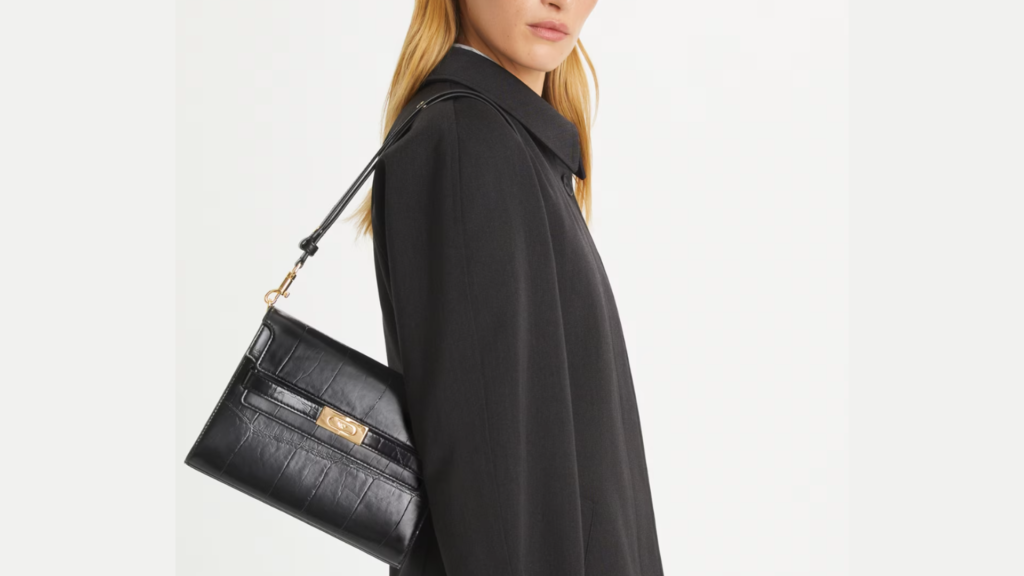 Woman carrying Tory Burch's Lee Radziwill Bag in black patterned leather