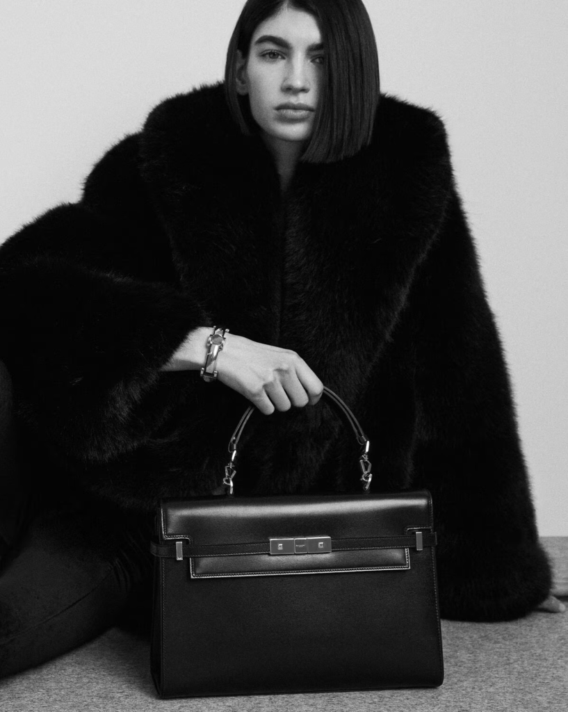 Woman holding the Saint Laurent Manhattan Bag in black leather