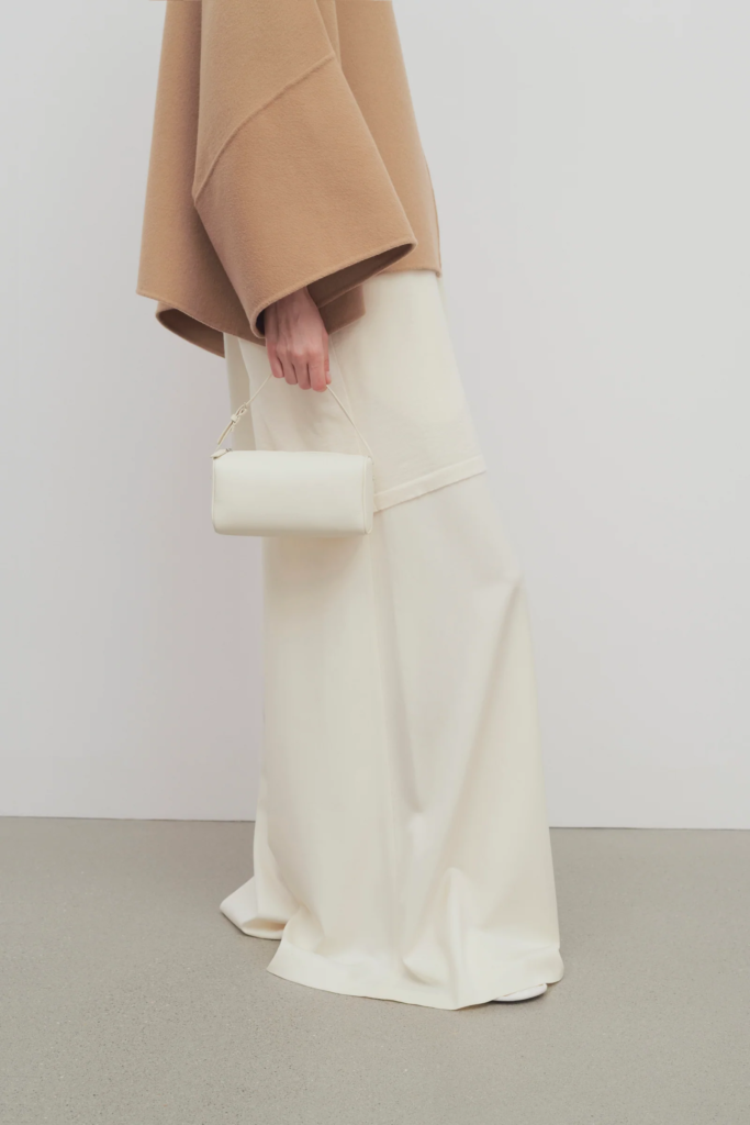 Woman holding The Row 90's Bag in Ivory